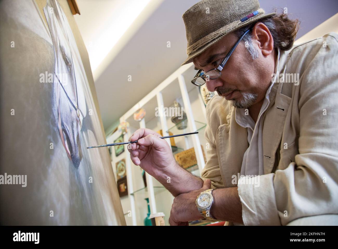 Doha, Qatar - March 05, 2022: Fine artist in his studio in the traditional Arab market called souq Wakif. Stock Photo