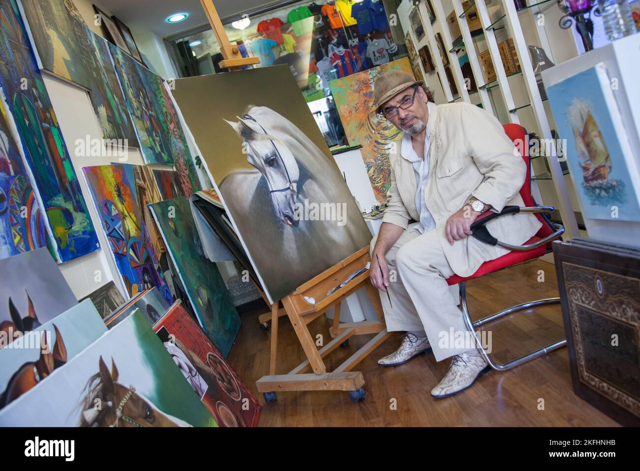 Doha, Qatar - March 05, 2022: Fine artist in his studio in the traditional Arab market called souq Wakif. Stock Photo