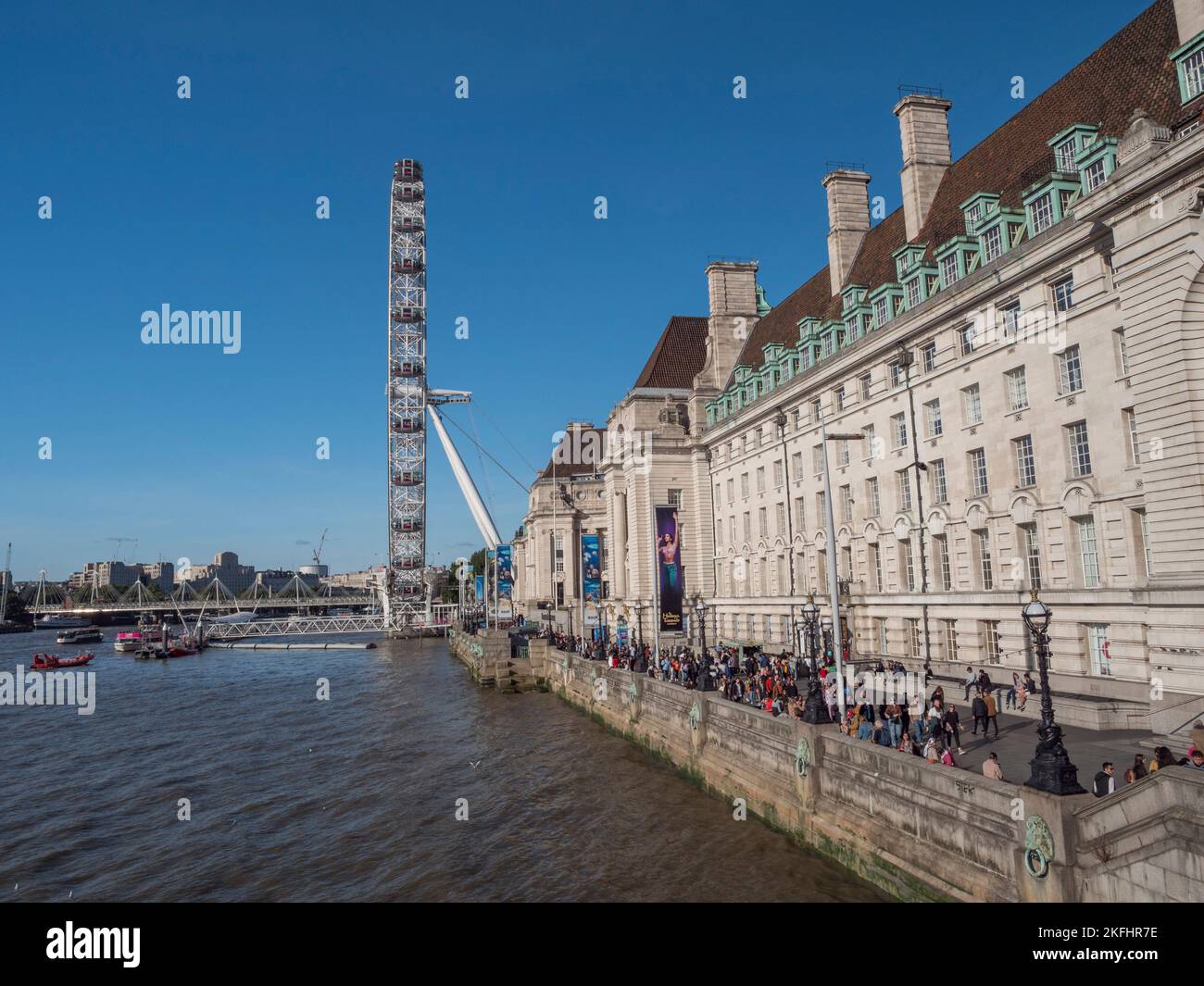 The London Eye on the banks of the River Thames beside County Hall, London, UK. Stock Photo