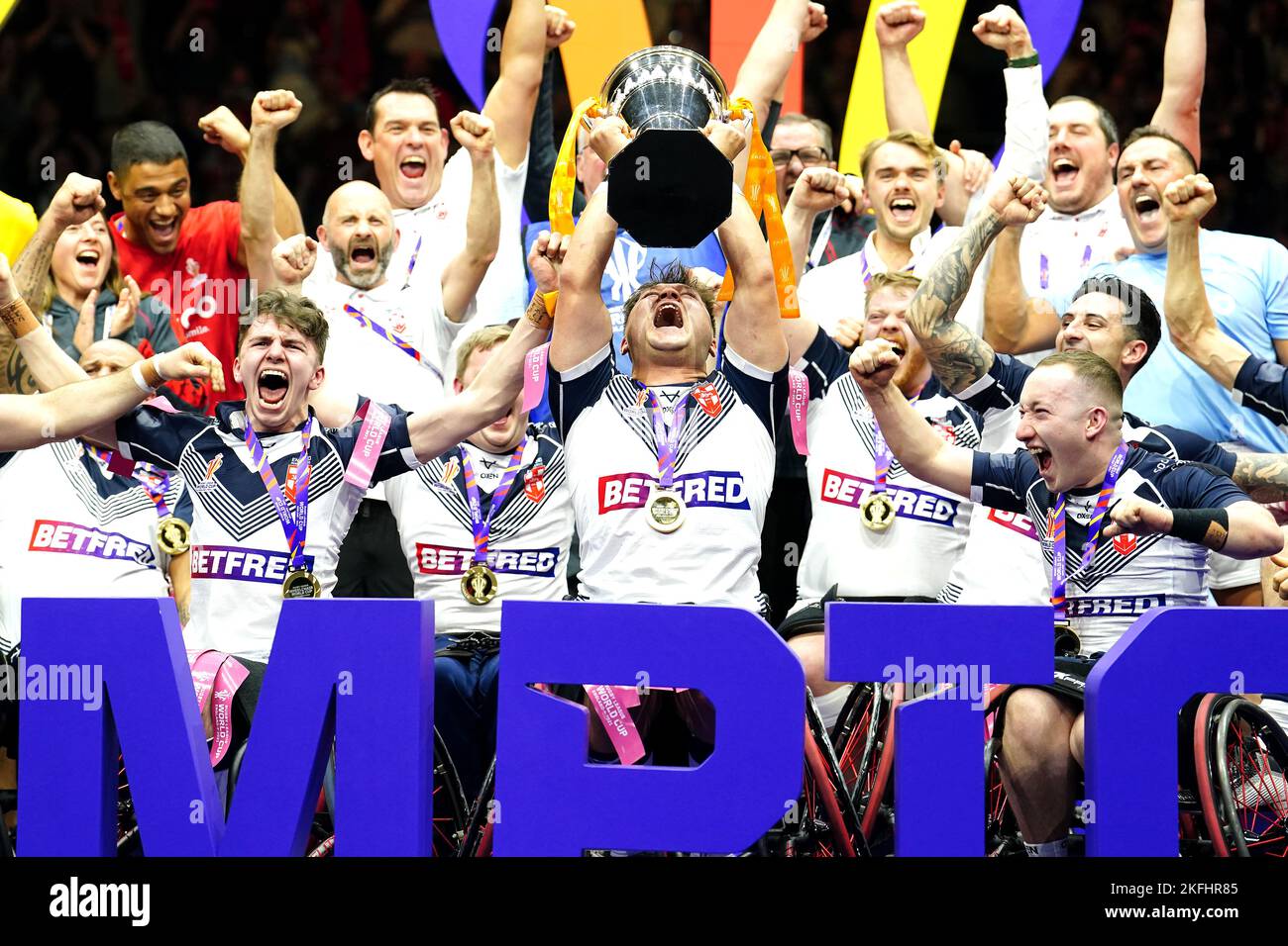 England's Tom Halliwell lifts the trophy with team-mates after victory in the Wheelchair Rugby League World Cup final match at Manchester Central. Picture date: Friday November 18, 2022. Stock Photo