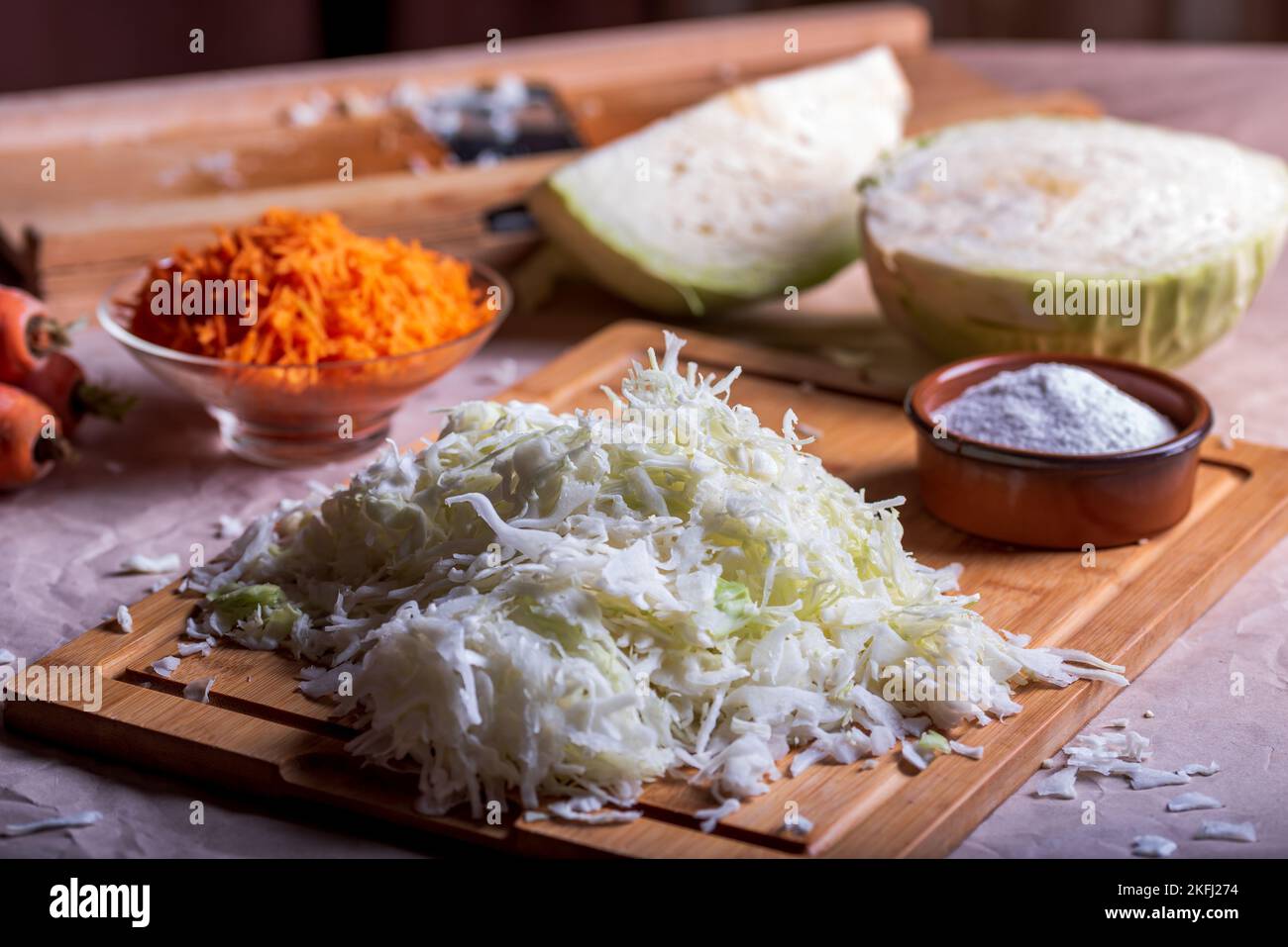 Prepare cabbage for fermentation. Cutting of cabbage on cutter. Homemade sauerkraut. Stock Photo