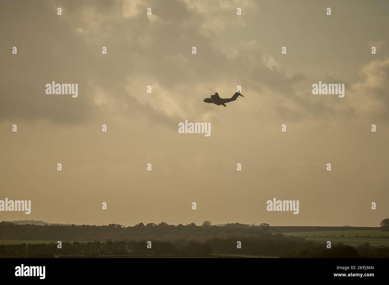 a royal air force Atlas A400M military cargo plane on a parachute drop run in late afternoon setting sun sky Stock Photo