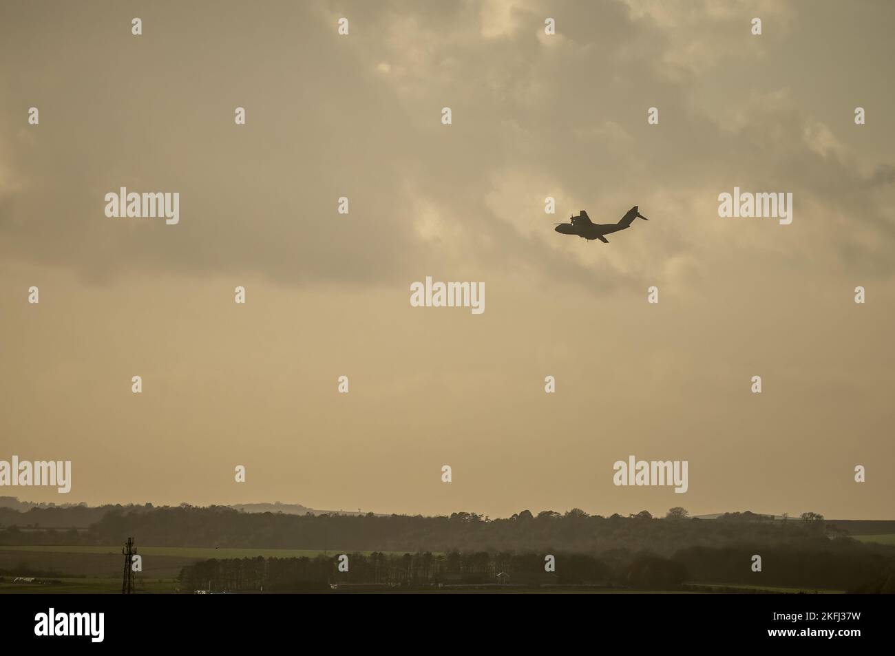 a royal air force Atlas A400M military cargo plane on a parachute drop run in late afternoon setting sun sky Stock Photo