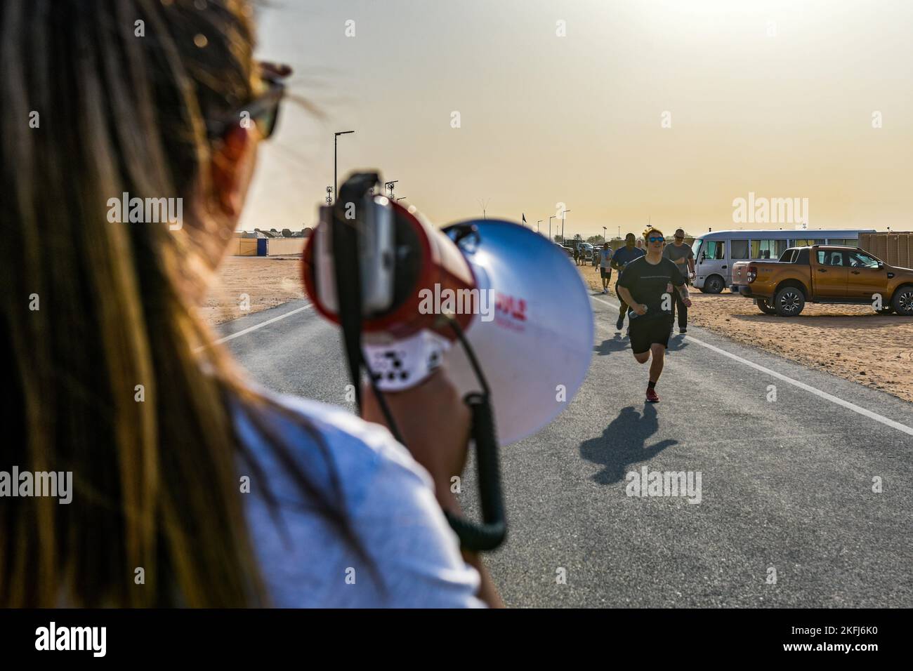 A U.S. service member deployed to Prince Sultan Air Base, Kingdom of Saudi Arabia, cheers on here comrades running a 5K, 10K or half marathon in celebration of the U.S. Air Force’s 75th Anniversary, Sept.18, 2022. The USAF official separated from the U.S. Army with the signing of the National Security Act of 1947 by former U.S. President Harry Truman. Fly, Fight and Win - Airpower Anytime, Anywhere! Stock Photo