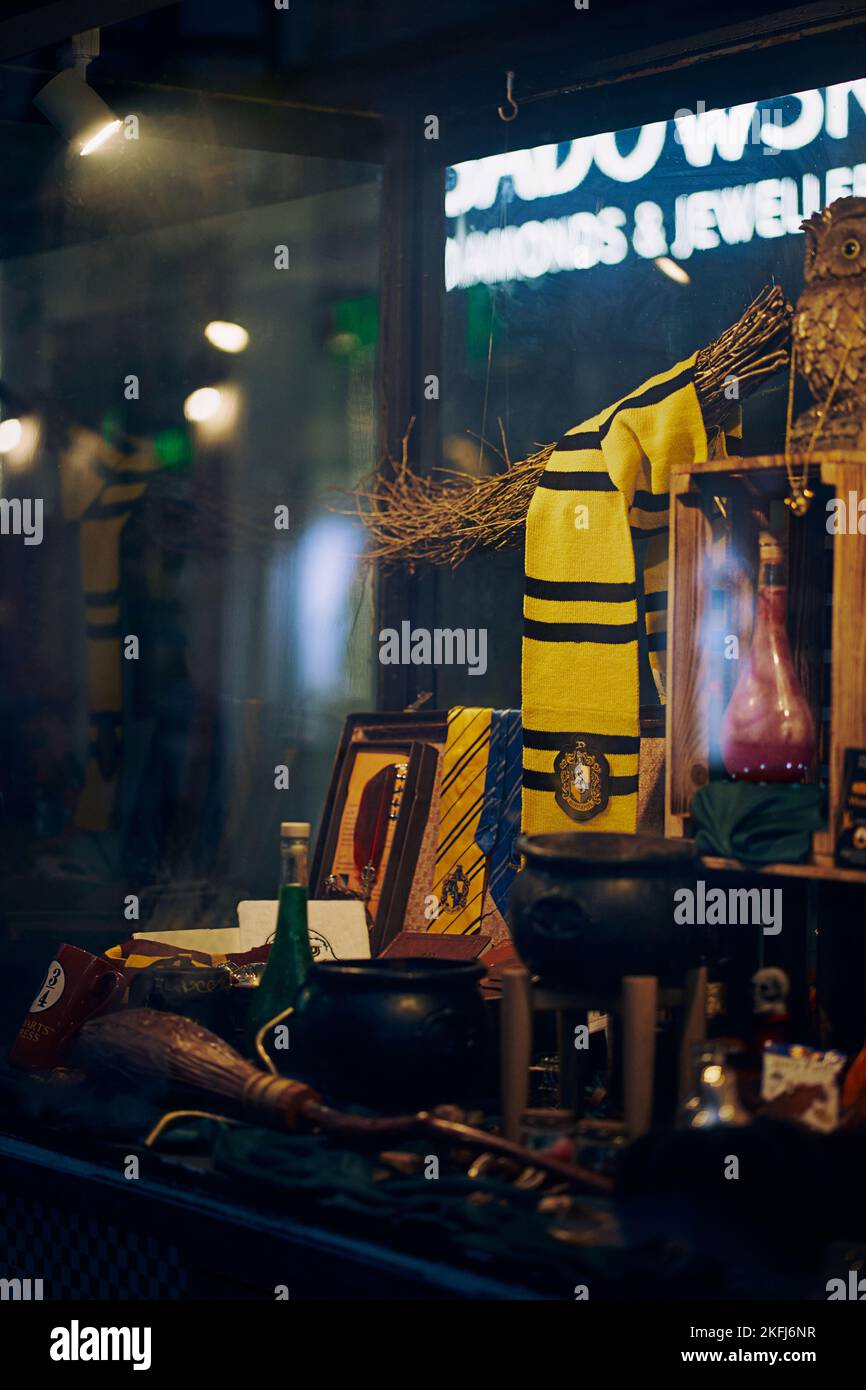 A vertical shot of objects behind the glass in harry potter store in ...