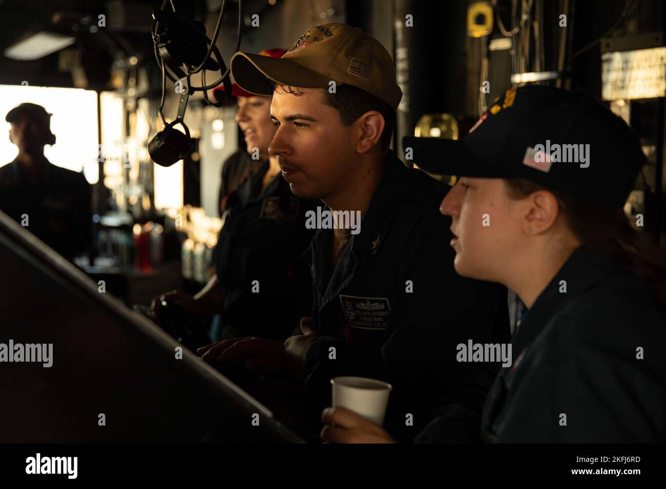 220918-N-LK647-0090 ATLANTIC OCEAN (Sept. 18, 2022) Gas Turbine Systems Technician (Electrical) 3rd Class Javier Fonseca-Diaz, center, and Gas Turbine Systems Technician (Electrical) 3rd Class Abby Howard stand watch on the bridge of the Ticonderoga-class guided-missile cruiser USS Normandy (CG 60) as part of a replenishment-at-sea with the Henry J. Kaiser-class oiler John Lenthall (T-AO-189) during Surface Warfare Advanced Tactical Training (SWATT). Normandy is underway as part of the Gerald R. Ford Carrier Strike Group conducting SWATT exercises to increase lethality, ensure combat readiness Stock Photo