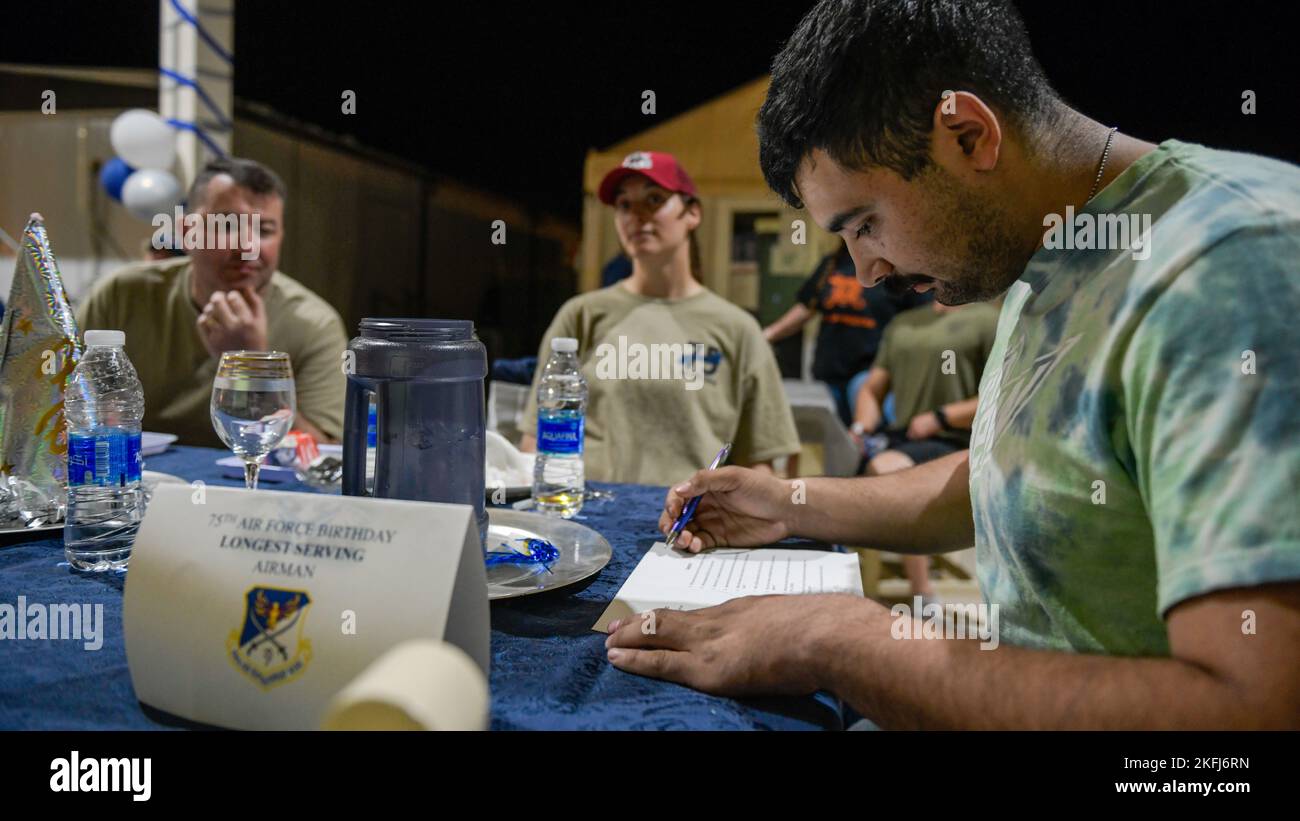 A U.S. service member deployed to Prince Sultan Air Base, Kingdom of Saudi Arabia, takes a U.S. Air Force history quiz during a USAF 75th Anniversary party at PSAB, Sept.18, 2022. The USAF official separated from the U.S. Army with the signing of the National Security Act of 1947 by former U.S. President Harry Truman. Fly, Fight and Win - Airpower Anytime, Anywhere! Stock Photo