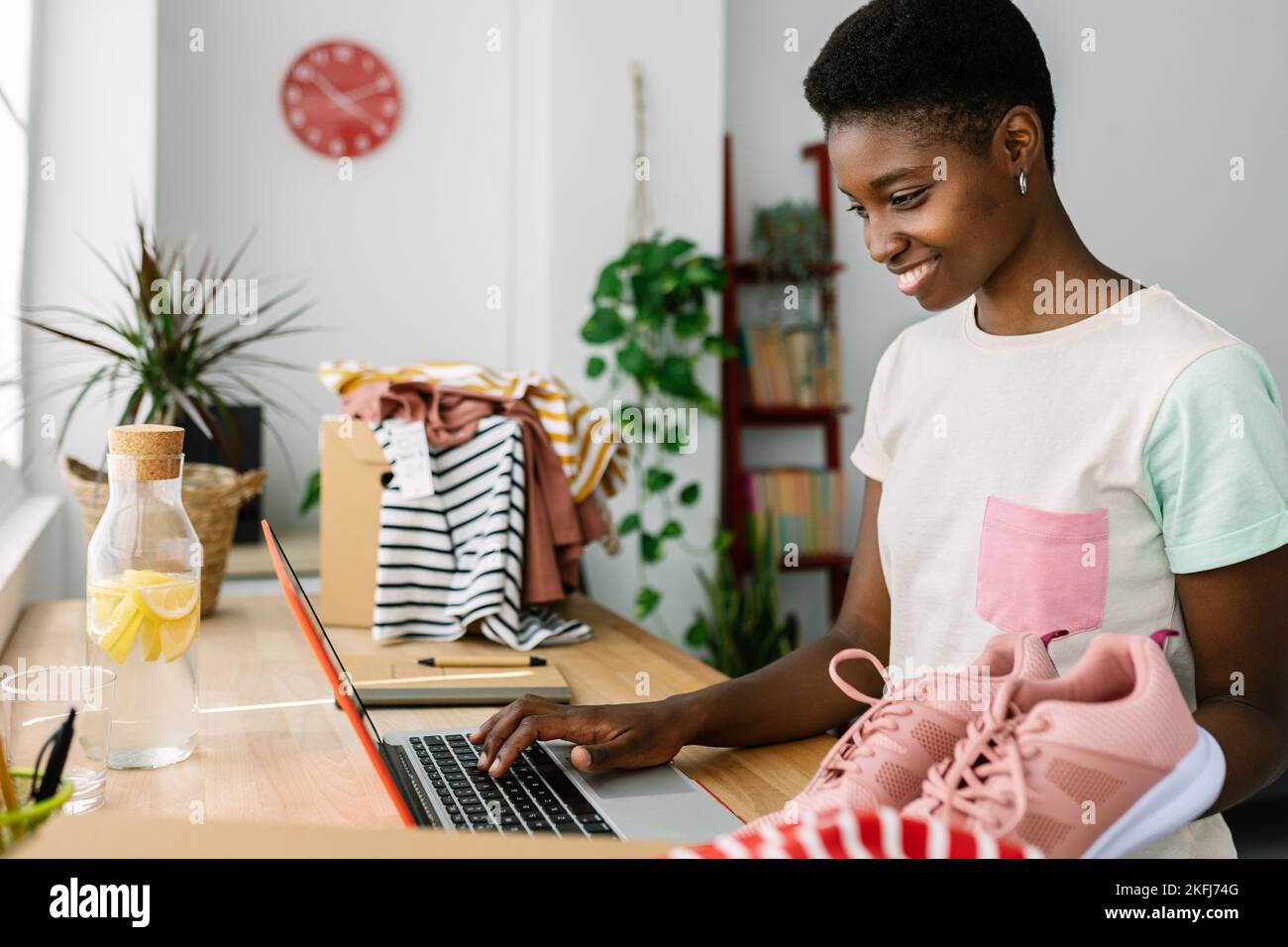 Trendy young small business owner woman working on laptop in office Stock Photo