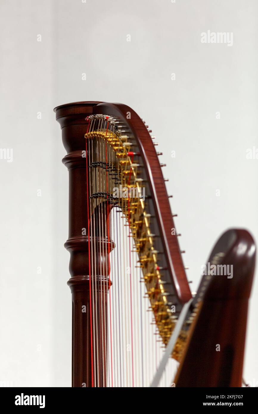 Partial view of a concert harp against a light background Stock Photo