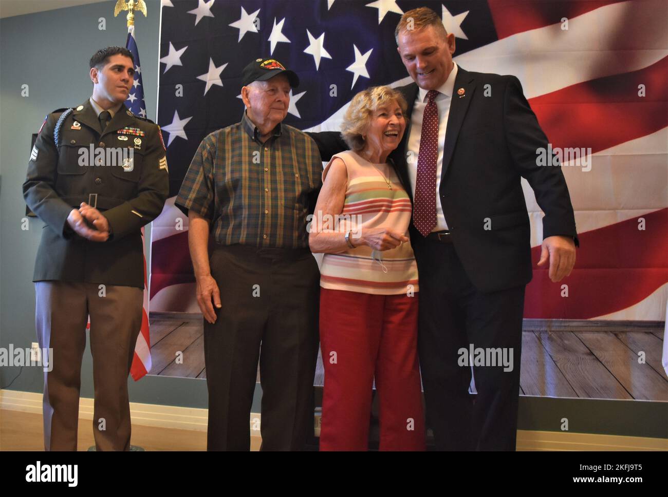 Korean War veteran Sgt. Norman Deck (second right) looks on as his wife