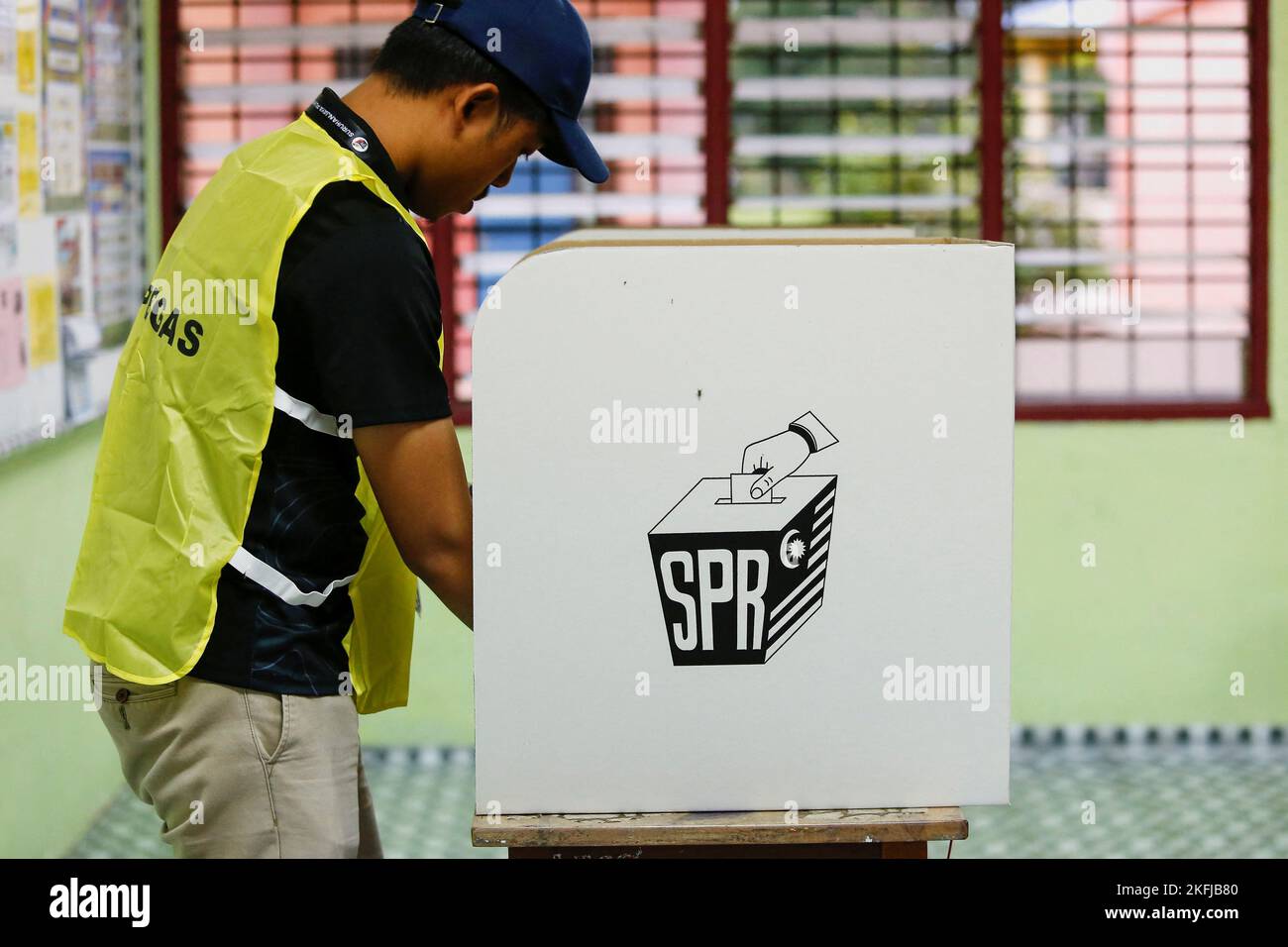 An election worker makes a final preparation at a polling station during Malaysia's 15th general election in Bera, Pahang, Malaysia November 19, 2022. REUTERS/Lai Seng Sin Stock Photo
