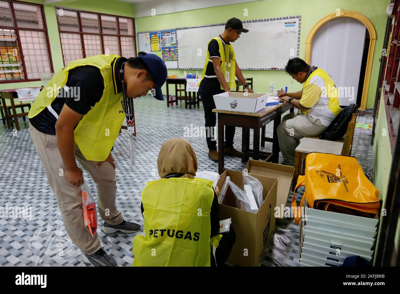 Election workers make a final preparation at a polling station during Malaysia's 15th general election, in Bera, Pahang, Malaysia November 19, 2022. REUTERS/Lai Seng Sin Stock Photo