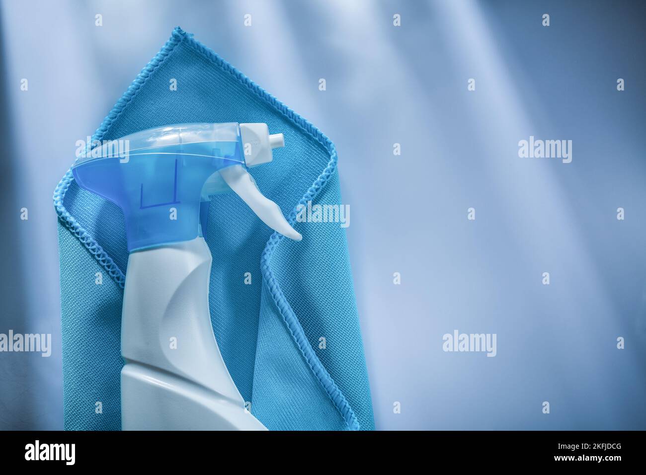 Blue washing rag sprayer on white surface Stock Photo - Alamy