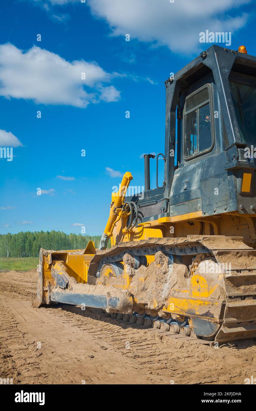 Bulldozer on sand view from back Stock Photo - Alamy