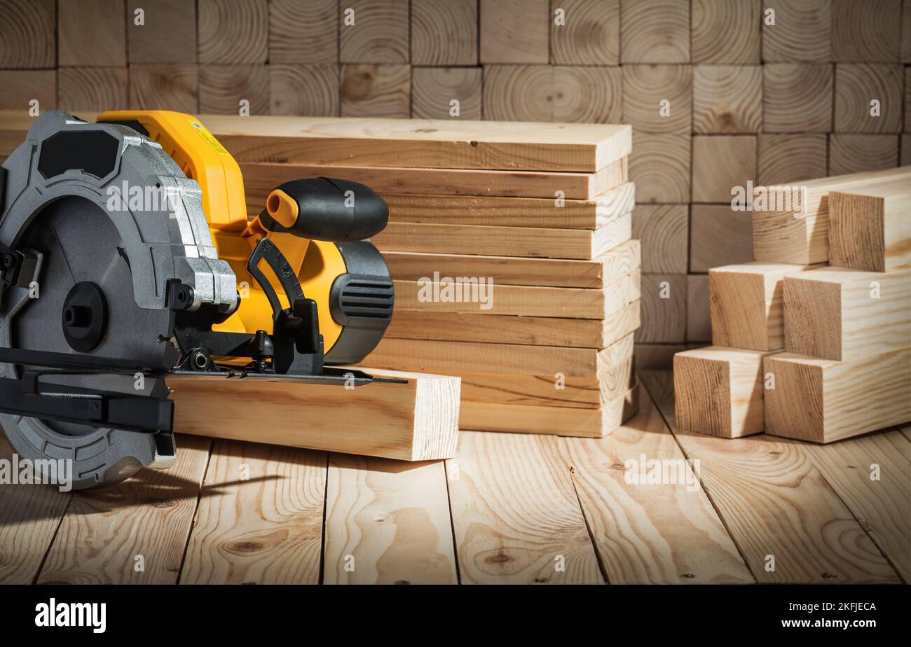 electric power tool corded circular hand saw on wooden background Stock Photo