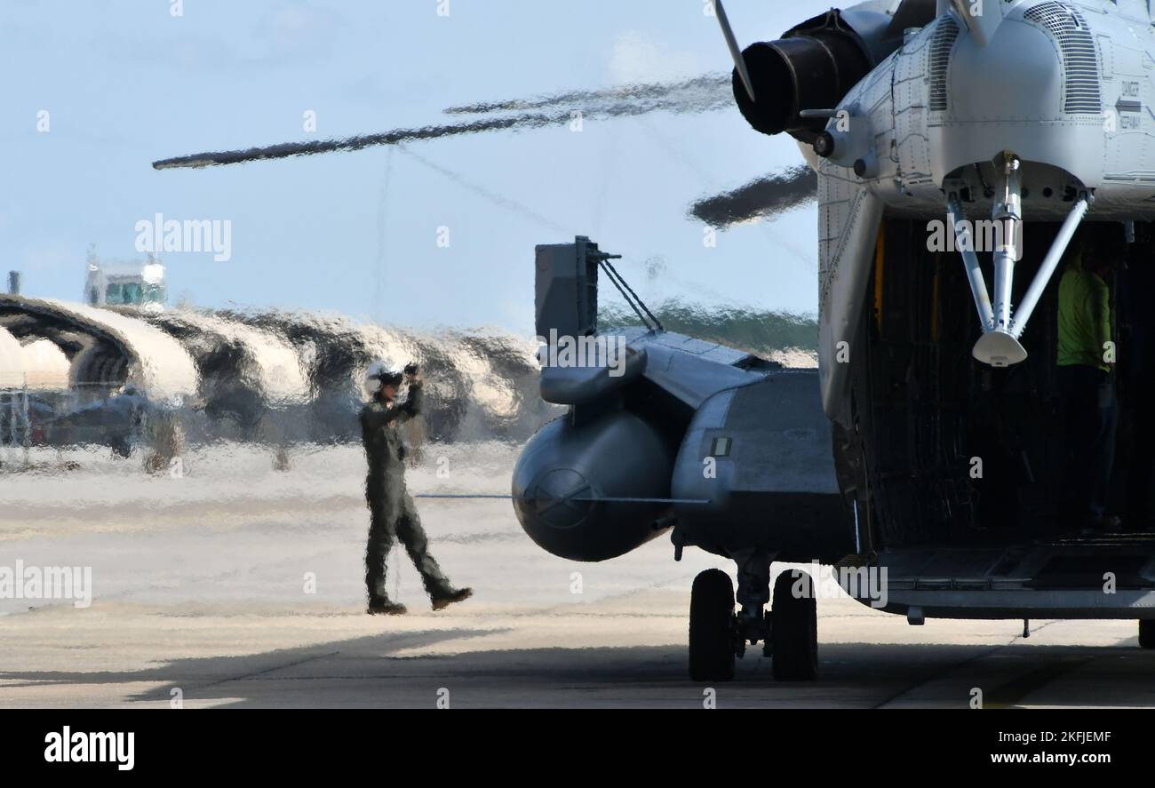 Cpl. Devon Schoff, a CH-53 crew chief at Fleet Readiness Center East (FRCE), signals to the pilot as the aircrew prepares to return a recently overhauled CH-53 helicopter to the fleet. In order to provide the fleet with quality and capable aircraft, Marines working in FRCE’s H-53 Military Branch oversee a range of critical functions including inspections and safety checks conducted during each phase of the maintenance, overhaul and repair process. (Photo by Joe Andes, Fleet Readiness Center East Public Affairs.) Stock Photo