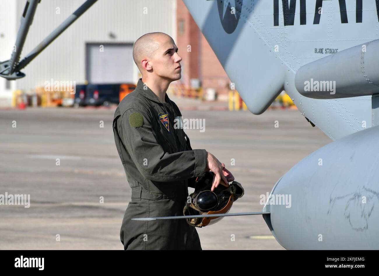 Cpl. Devon Schoff, a CH-53 crew chief at Fleet Readiness Center East (FRCE), prepares to don his protective gear prior to conducting a functional check flight inspection on a recently overhauled CH-53 helicopter. In order to provide the fleet with quality and capable aircraft, Marines working in FRCE’s H-53 Military Branch oversee a range of critical functions including inspections and safety checks conducted during each phase of the maintenance, overhaul and repair process. (Photo by Joe Andes, Fleet Readiness Center East Public Affairs.) Stock Photo