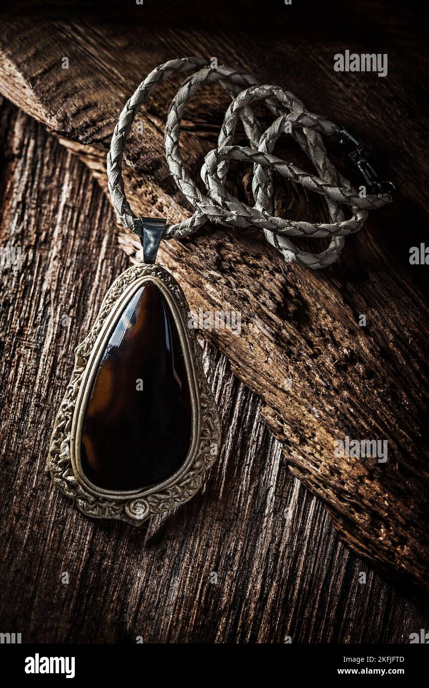 pendant with dark gem on vintage wood Stock Photo