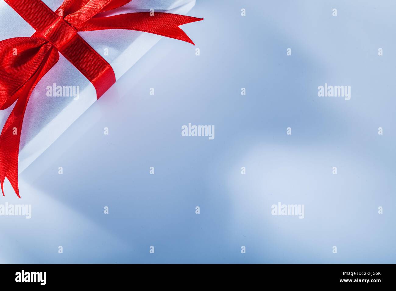 Red gift box with tied ribbon on white background Stock Photo - Alamy