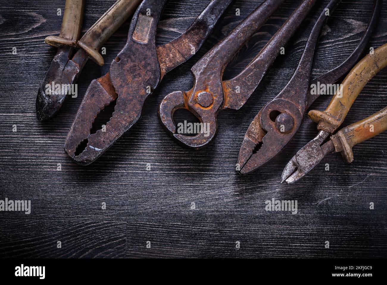 Rusty nippers pliers tin snips wire-cutter on wooden board Stock Photo ...