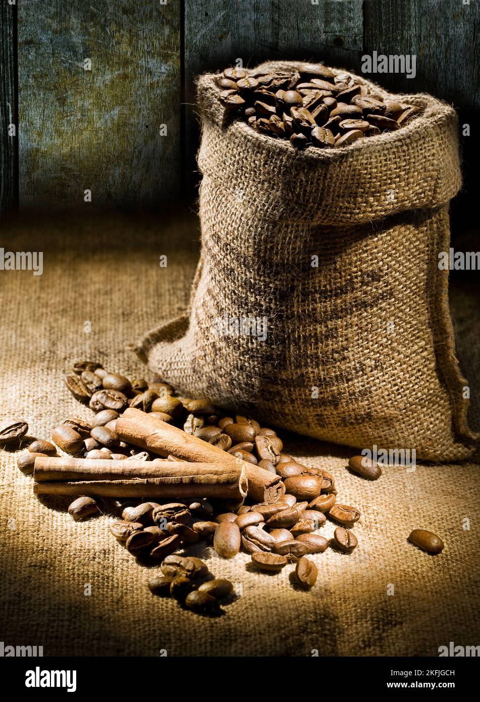sack of coffee beans on a background of old boards Stock Photo - Alamy