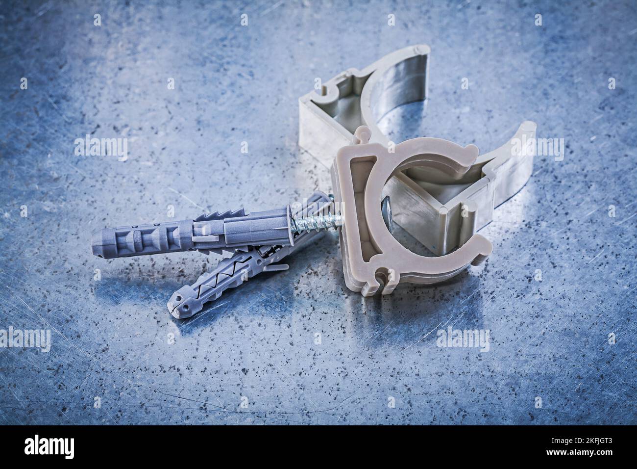 Stack of pipe clamps on metallic background construction concept. Stock Photo