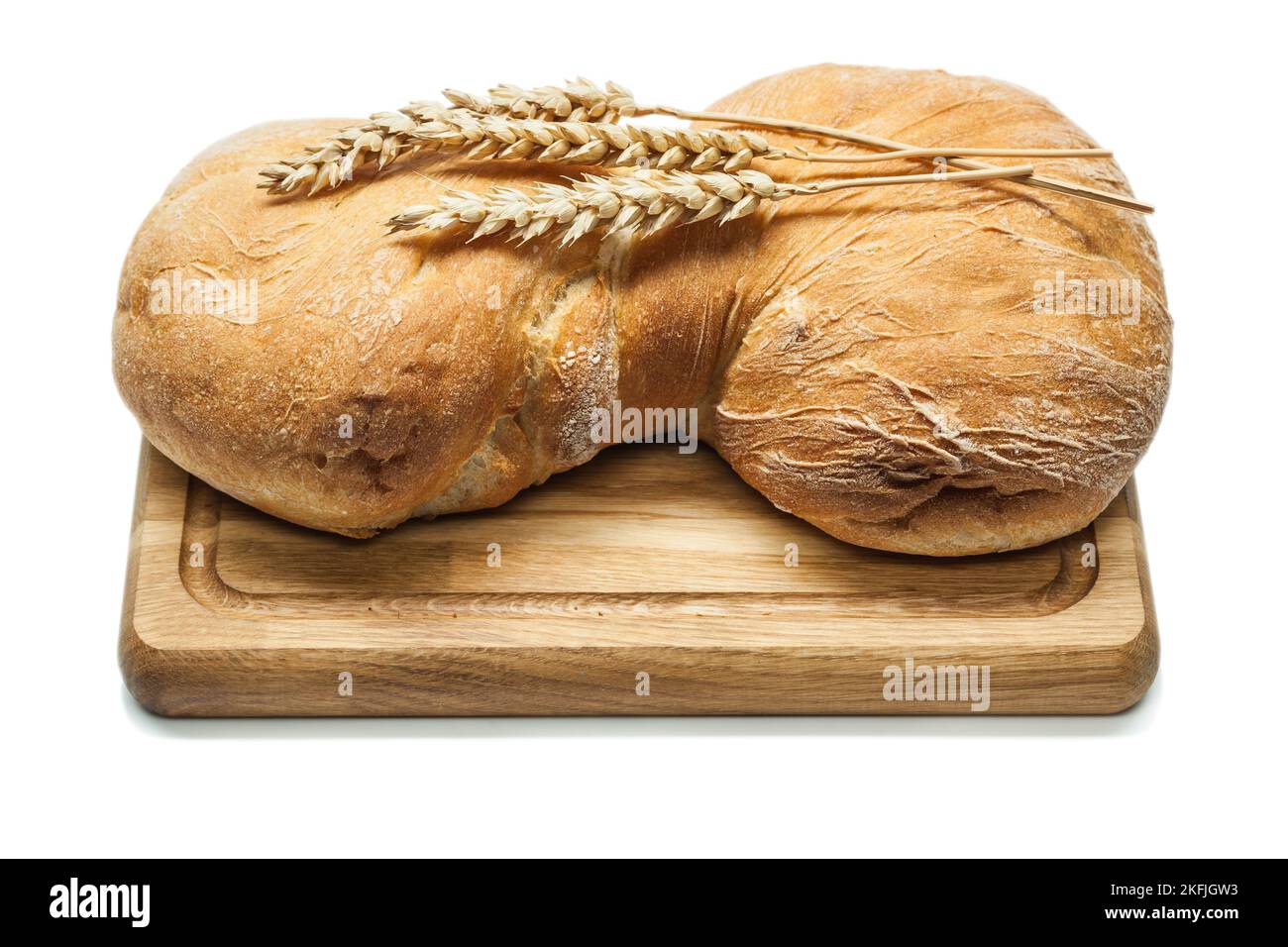 sweet bread on carving board and wheat ears isolated white Stock Photo ...