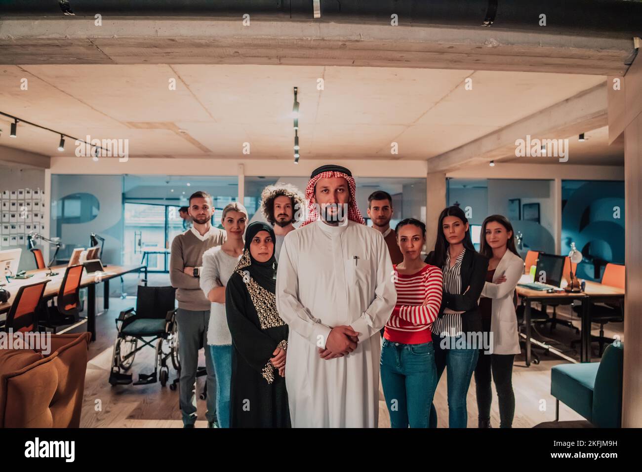 A diverse group of successful business people in a modern glass office ...