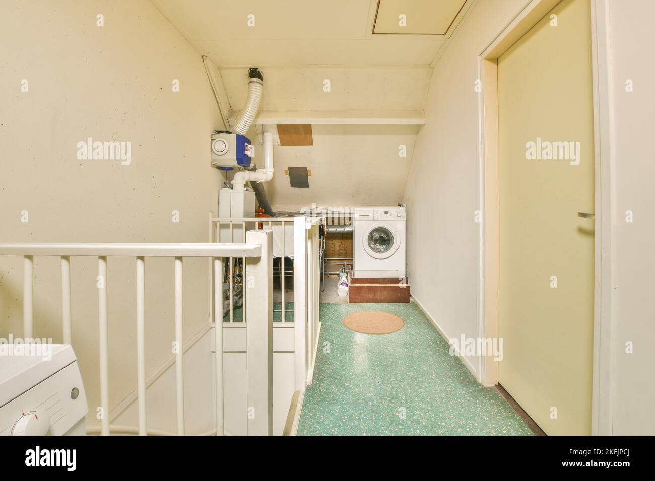 Attic corridor of an apartment building with pipes and metering devices