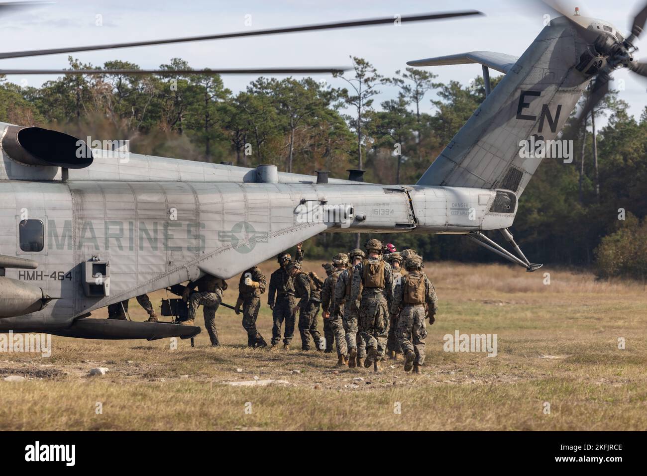 U.S. Marines with the Maritime Special Purpose Force, 26th Marine Expeditionary Unit (MEU), load into a CH-53E Super Stallion helicopter during a Fast Rope Masters course at Stone Bay, on Marine Corps Base Camp Lejeune, North Carolina, Nov. 16, 2022. This training prepares service members for helicopter-borne insertion and extraction operations and certifies them to oversee rope operations with their respective units. The Fast Rope Masters course is one of several Expeditionary Operations Training Group taught courses Marines and Sailors of the MEU receive prior to deployment. (U.S. Marine Cor Stock Photo