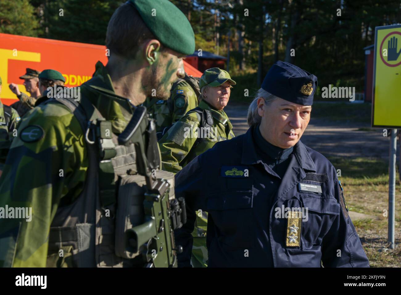 Swedish Marine Capt. Jacob Lindholm (left), Swedish ground force commander, escorts Swedish Navy Rear Admiral Ewa Skoog Haslum (right), Chief of Swedish Navy, while visiting U.S. and Swedish Marines during exercise Archipelago Endeavor 22 (AE22) on Berga Naval Base, Sweden, Sept. 21, 2022. AE22 is an integrated field training exercise that increases operational capability and enhances strategic cooperation between the U.S. Marines and Swedish forces. Stock Photo