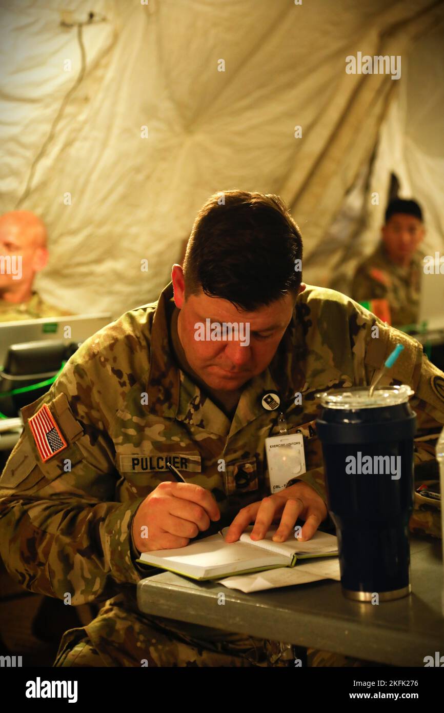 Sgt. 1st Class Thomas Pulcher, operations watch NCO for U.S. Army Central, takes notes during Exercise Lucky Strike 2022 at Fort Gordon, Georgia, Sept. 21, 2022. During Exercise Lucky Strike, USARCENT deployed its contingency command post, demonstrating an ability to rapidly deploy within its area of responsibility. Stock Photo