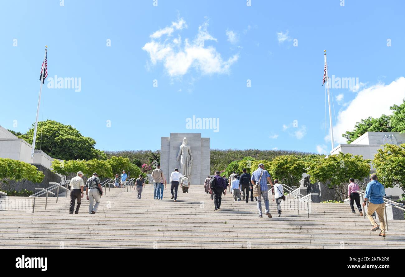 Members of a Defense POW/MIA Accounting Agency scientific summit walk up steps toward the Honolulu Memorial during a tour of the National Memorial Cemetery of the Pacific in Honolulu, Hawaii, Sept. 21, 2022. On both sides of the stairs leading to the memorial are eight courts of with the inscribed names of Americans missing from World War II, the Korean War and the Vietnam War. Stock Photo