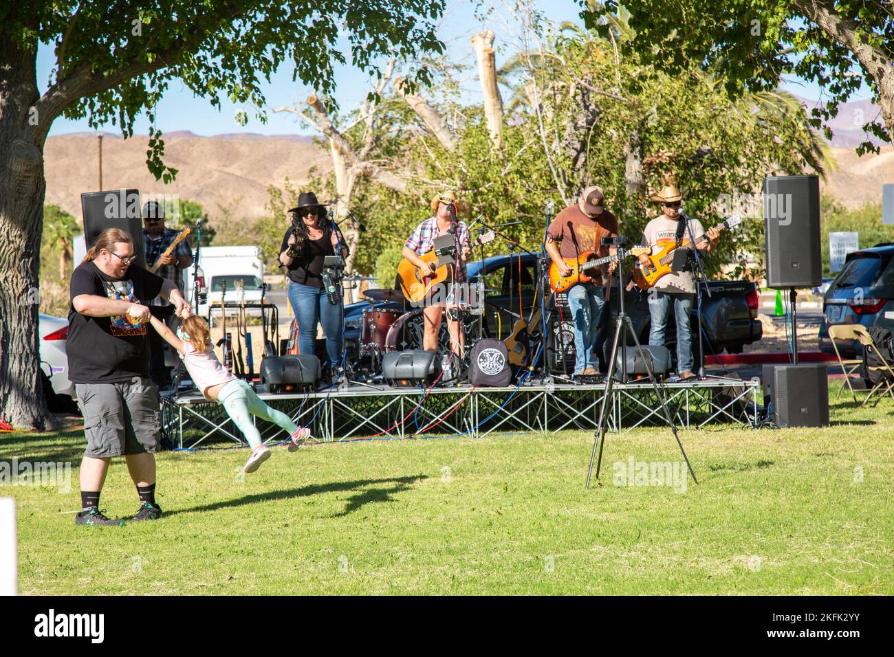 Families enjoy a little play time while a live band plays rock and roll