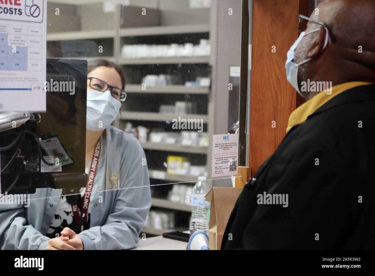 Charles Newsome picks up a prescription from pharmacist Tori Williams at Reynolds Army Health Clinic at Fort Sill. RAHC launched MHS GENESIS in March of 2022 and were back to 100% by July. Stock Photo