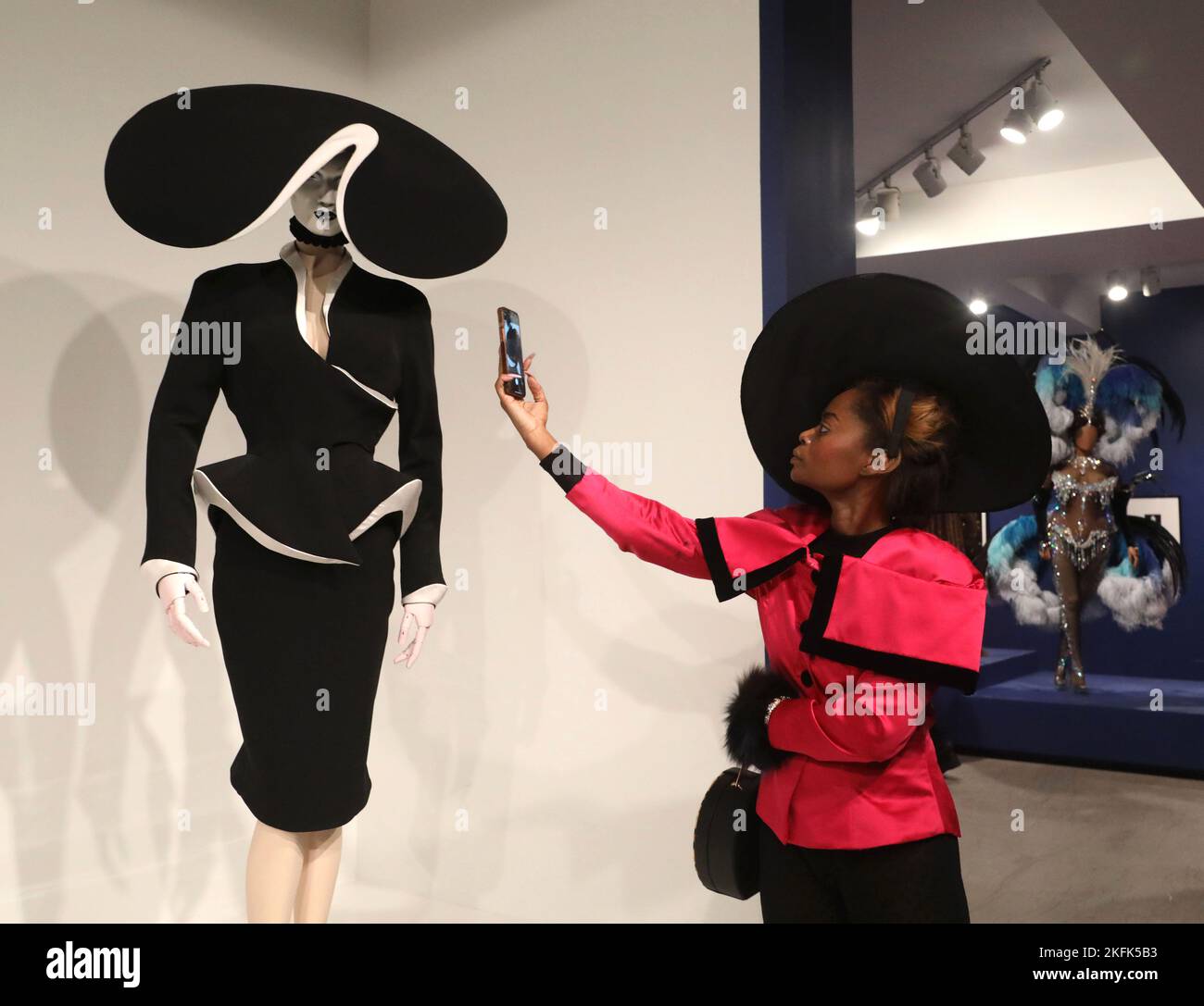 November 18, 2022, New York City, New York, USA: A woman looks at fashion  by designer Thierry Mugler (1945 - 2022) on display at the Brooklyn  Museum's 'Thierry Mugler: Couturissime' Exhibition from