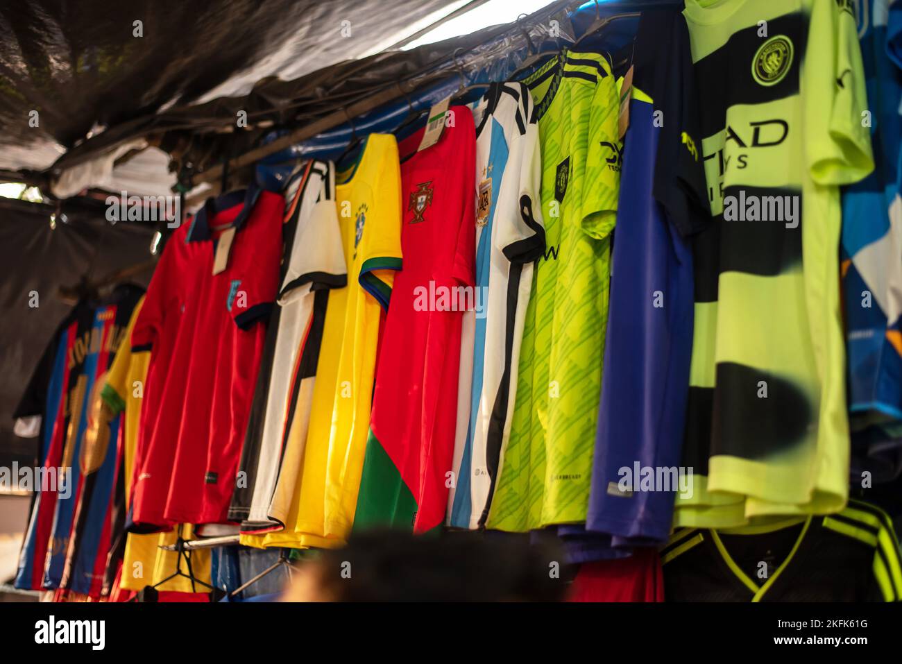 Calcutta, India - November 15, 2022. Soccer jerseys of various country are hanging in a retail shop to sell. Stock Photo