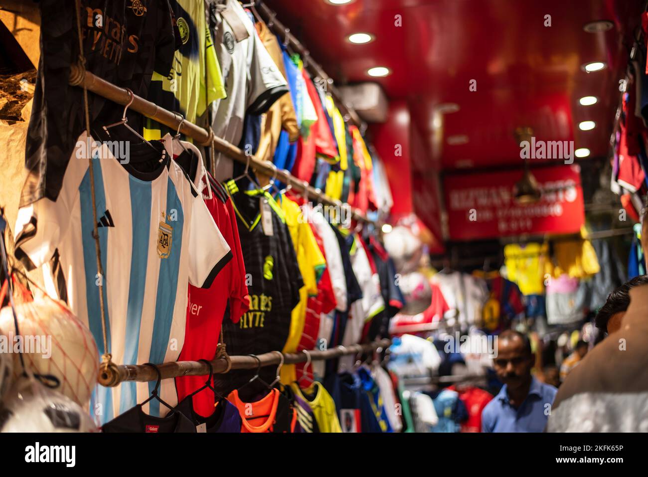 Calcutta, India - November 15, 2022. Soccer jerseys of various country are hanging in a retail shop to sell. Stock Photo