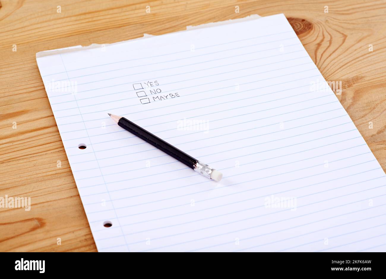 Make your choice. A writing pad with the words yes, no and maybe in check boxes. Stock Photo