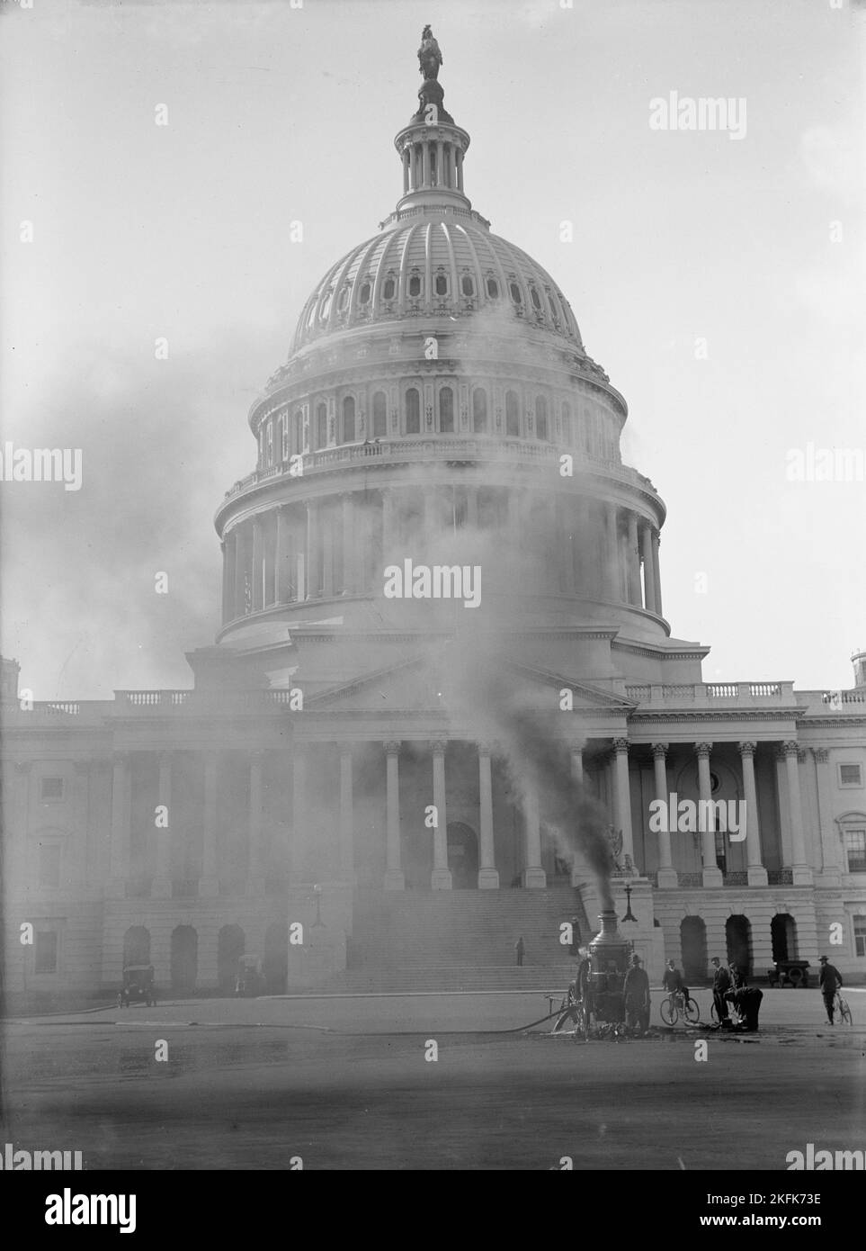 U.S. Capitol Cleaning Exterior, 1913. Machinery in foreground, hose