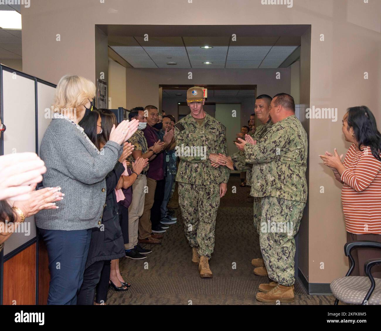 ASAN, Guam (Sept. 22, 2022) - Capt. Michael R. Baker, a Navy Chaplain, receives an ovation for his dedicated service from military and civilian personnel from Joint Region Marianas, Sept. 22. Chaplain Baker is continuing his service at U.S. Fleet Cyber Command, Ft. Meade, MD. Stock Photo