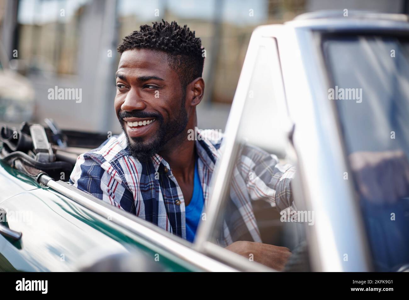 Life is too short to drive boring cars. a happy young man driving in his convertible. Stock Photo