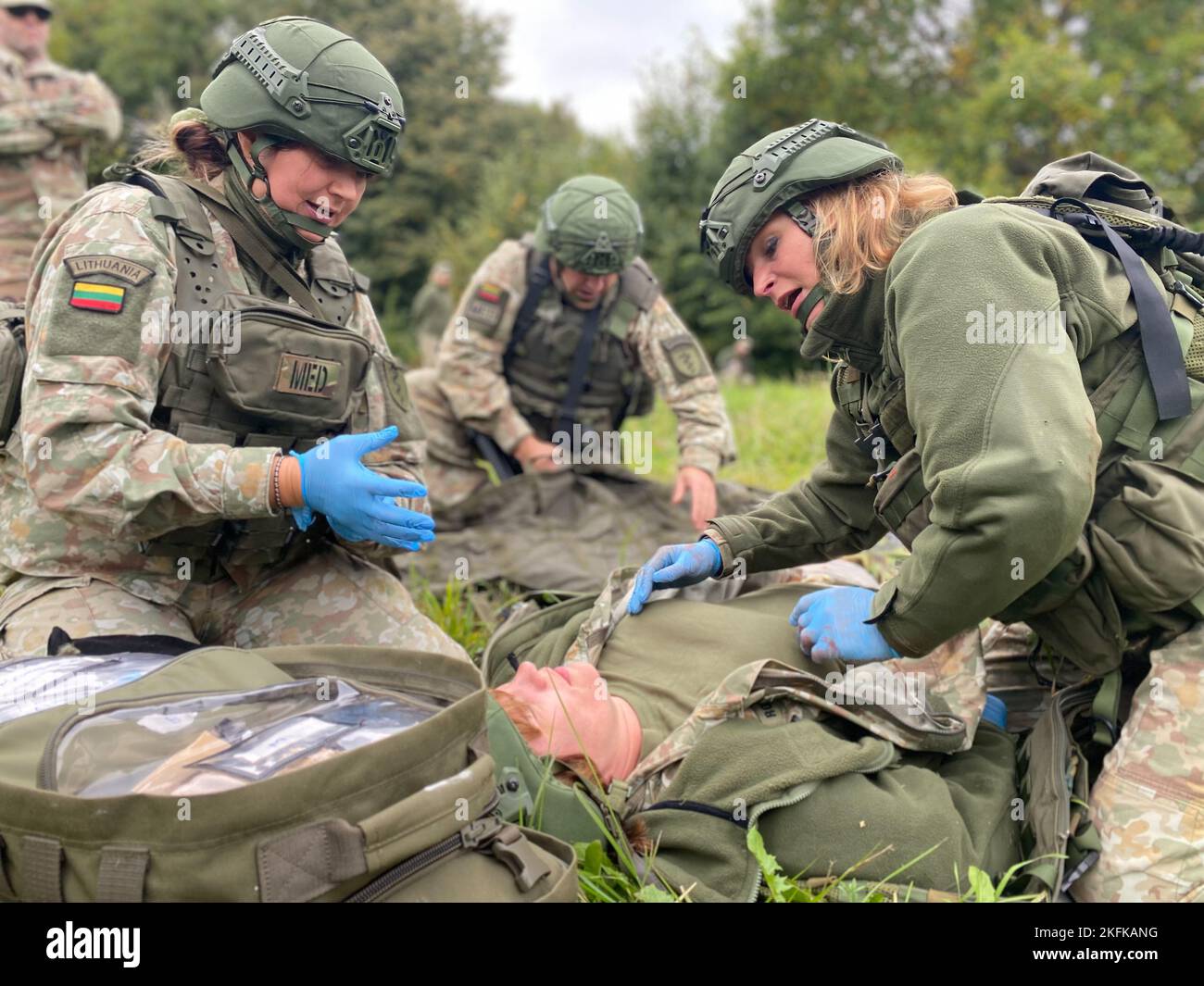 Lithuanian nurses Karile Vasilianuskiene and Staff Sgt. Adrone Vasiliauskaite practice tactical field care on a simulated casualty during a trauma lane in Kaunas, Lithuania, 22 September, 2022. Stock Photo