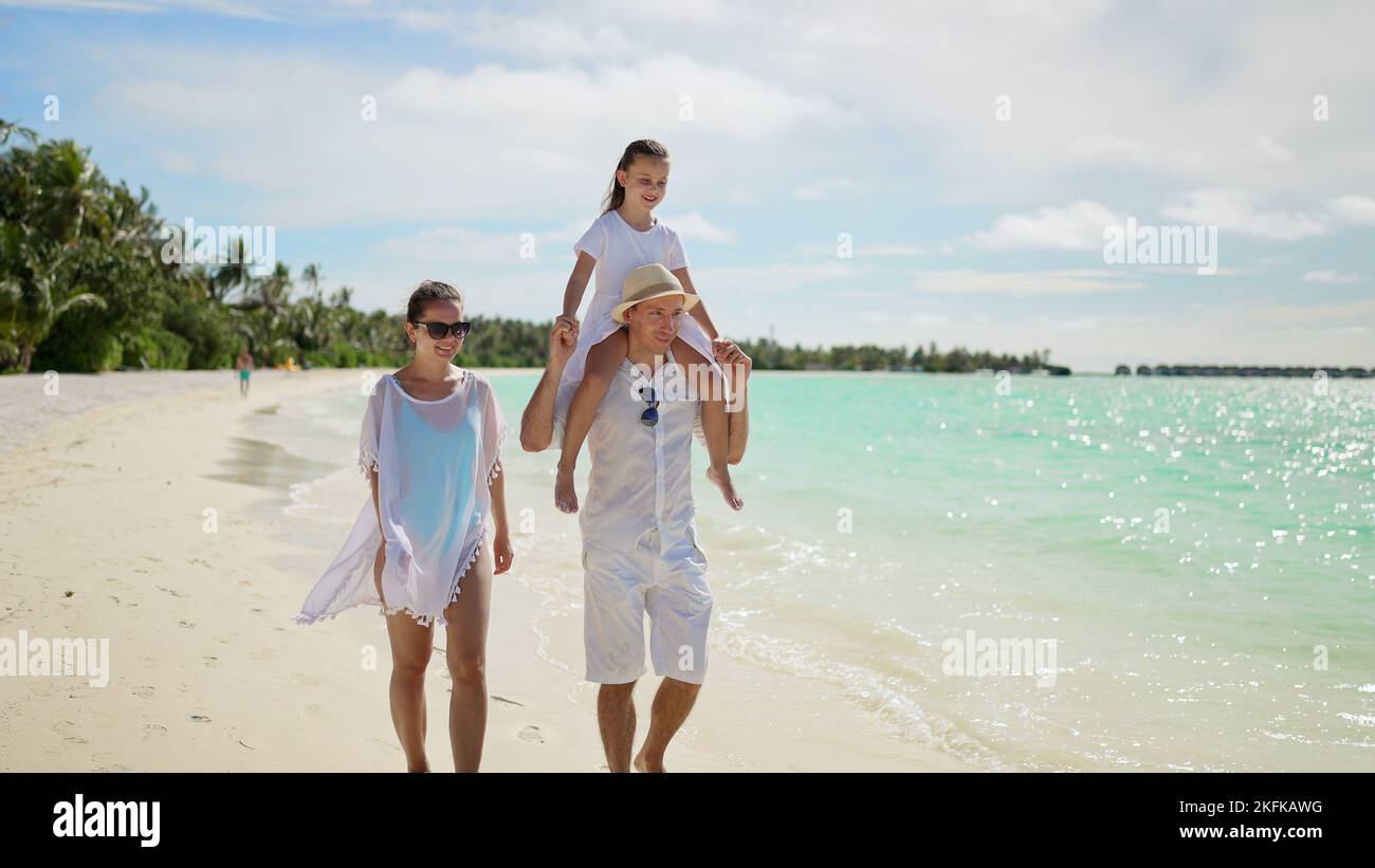 family-with-child-daughter-together-on-beach-summer-vacation-stock