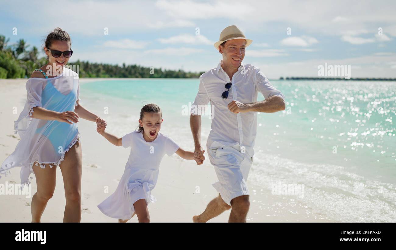 Happy family running on beach hi-res stock photography and images - Alamy