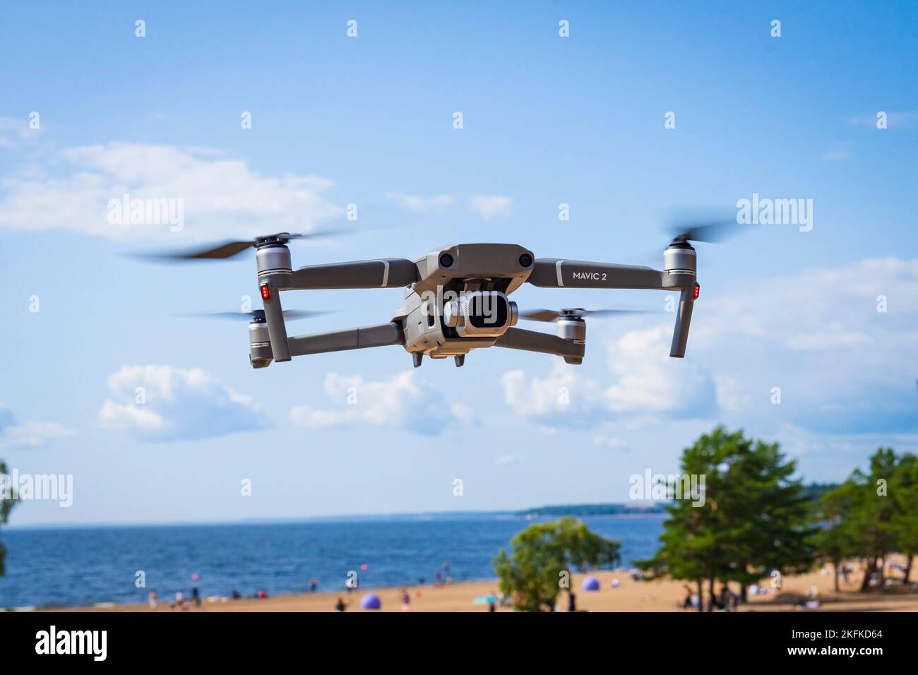 Sankt-Petersburg, Russia 10 August 2019: DJI Mavic 2 pro hovering in nature on the seashore over the beach and blue sky with hasselblad camera Stock Photo