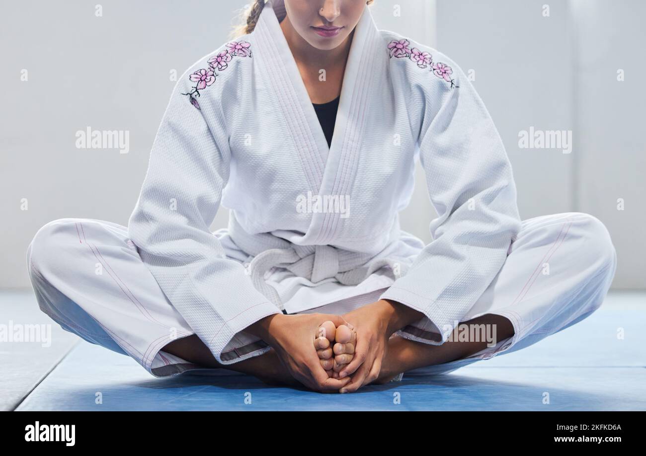 Warm up, legs and woman in karate training, learning martial arts and