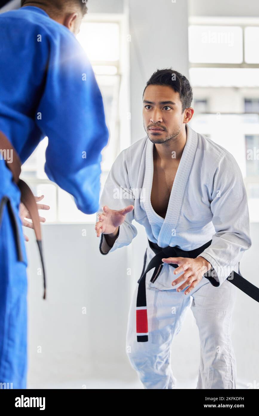Men, martial arts and karate training in dojo to practice fighting skill. Taekwondo, fitness or self defense class for workout, battle exercise or Stock Photo