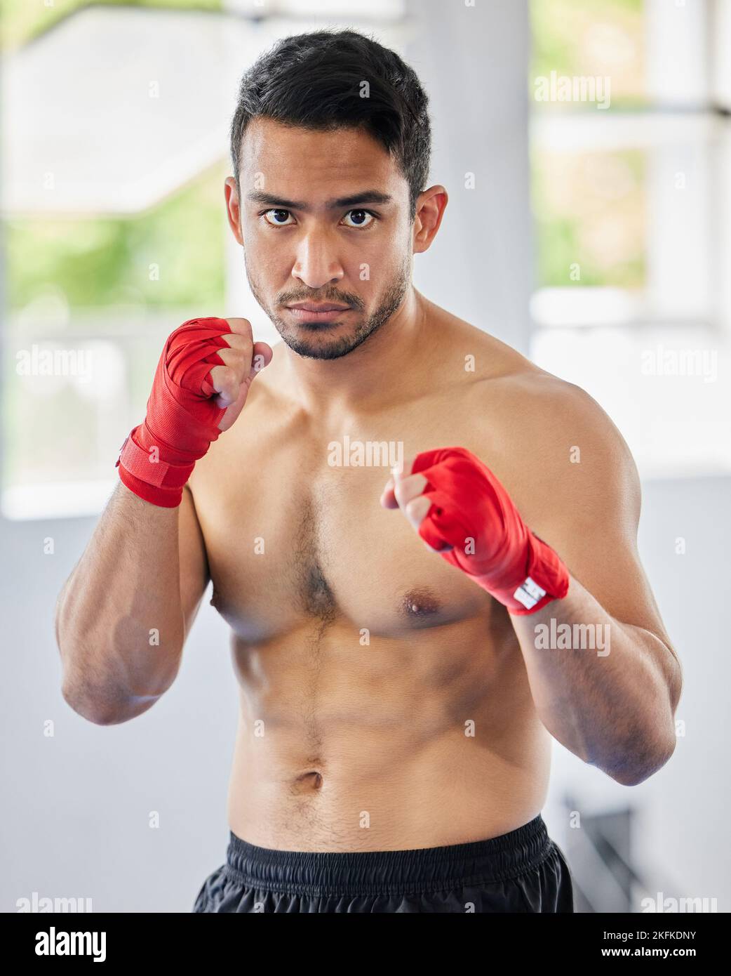 Fight, fist and kickboxing athlete man looking serious, angry and ready for martial arts exercise, training and competition. Asian sports or Muay thai Stock Photo