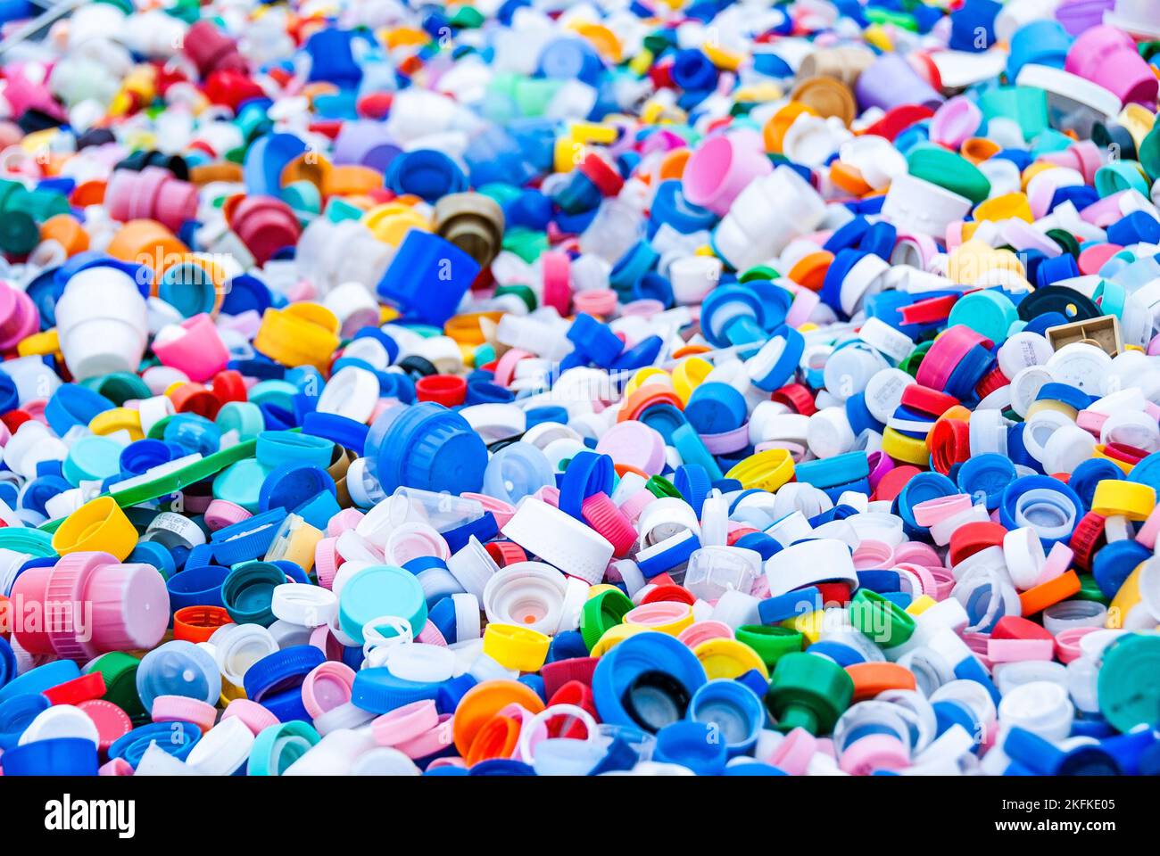 Sorting impressive amount of bottle plastic caps of different colors ...